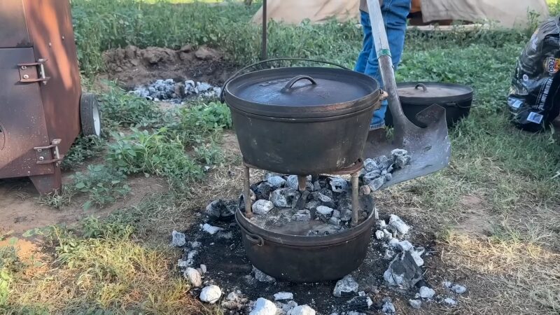 A Rustic Outdoor Cooking Setup with A Dutch Oven